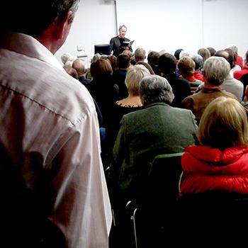 Linden MacIntyre reading to a group of people