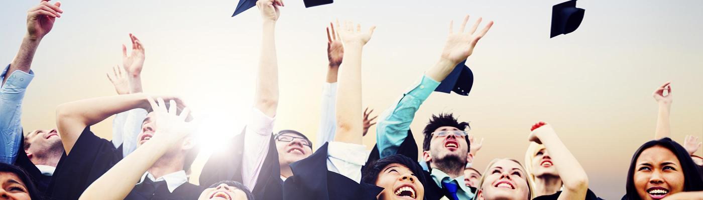Graduating students throwing their caps in the air