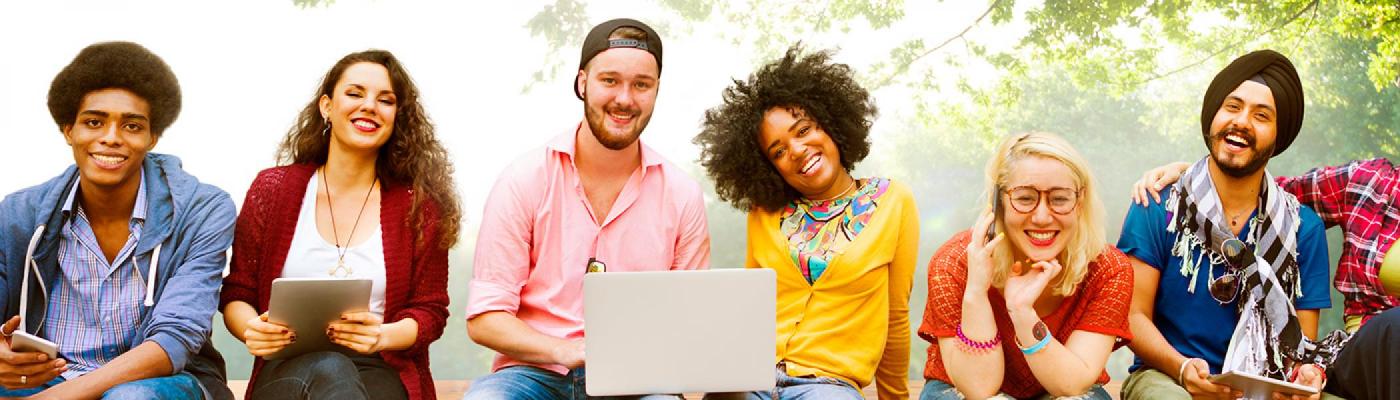 Six people sitting looking at camera smiling