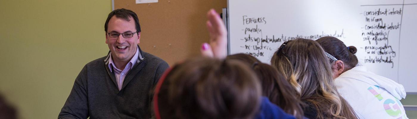 Students looking at faculty, raised hands
