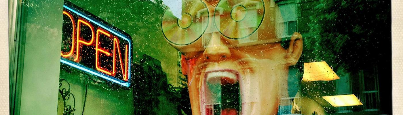 Window front displaying statue of man yelling