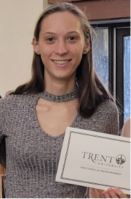 person with long brown hair holding a certificate