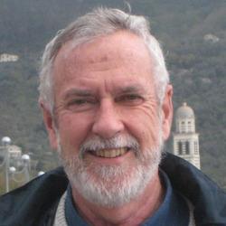 person with pale skin, grey hair and beard