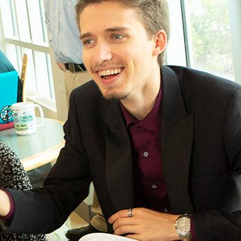 Group of students sitting around a table discussing with each other