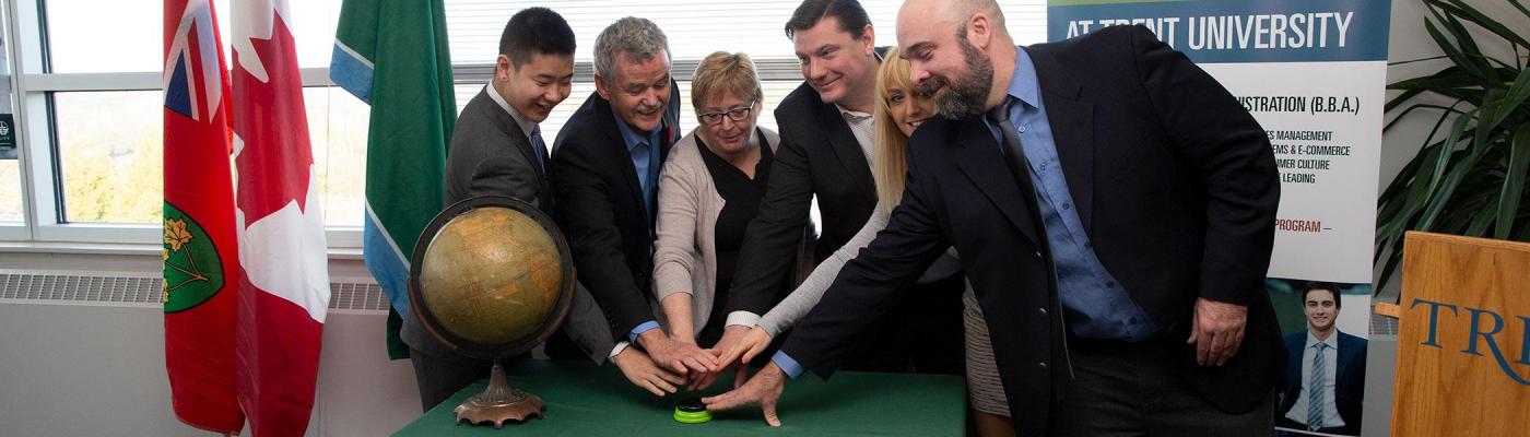 Dr. Leo Groarke with 5 other people celebrating the beginning of the School of Business