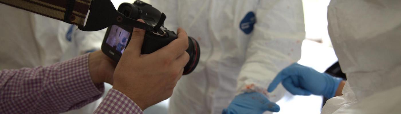 Someone taking a photo of blood on a glove