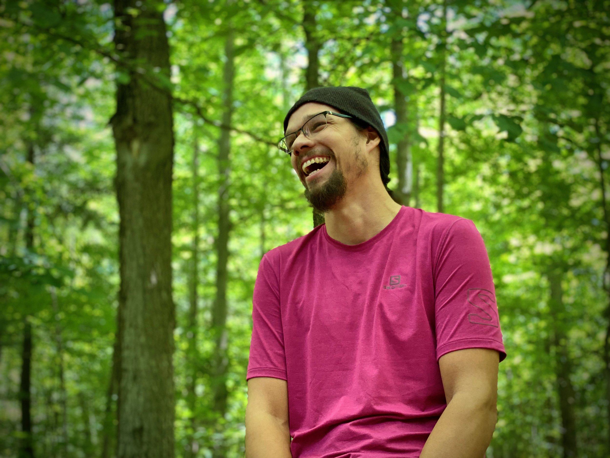 Joe Pitawanakwat smiling in a forest