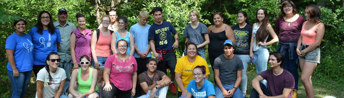 FPHL Department team holding paddles and posing for a group photo in the FPHL Gathering Space