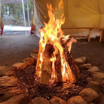 A fire lit within the Peterborough campus tipi