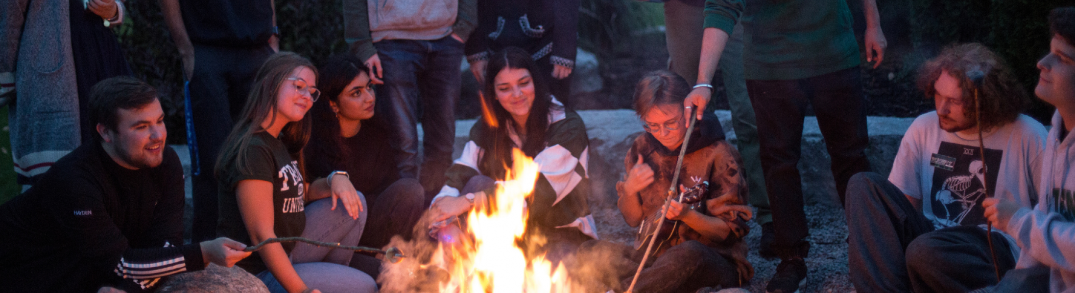 students around bonfire