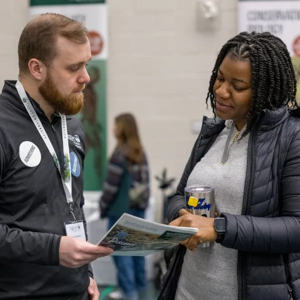 An advisor speaking with a teacher