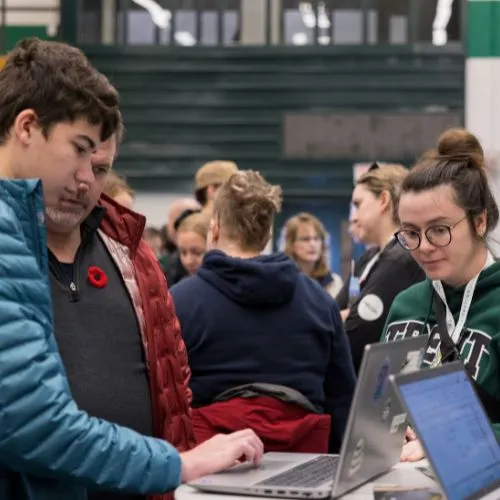 A student uses a laptop to apply at Trent in person