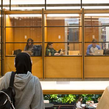 View from the top of the stairs at Bata library showing students working in study carols