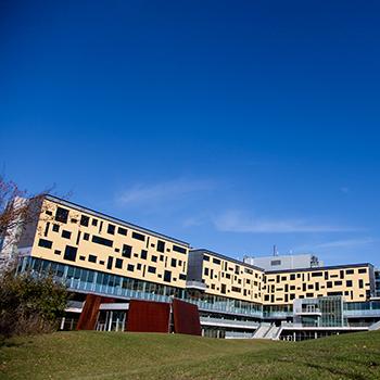 Exterior view of Gzowski College bulding in the summer time around mid-day