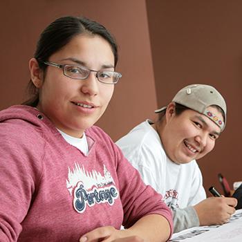 Indigenous students sitting at a project table in Gzowski College