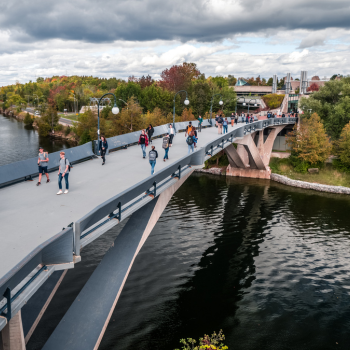 Image of students walking on the bridge. 