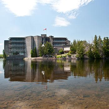 Trent's Bata Library from across the Otonabee river on a cloudless, summer day