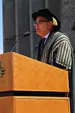 Don Tapscott on stage in Regalia during convocation.