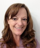 Christine Salo with long brown hair smiling into the camera