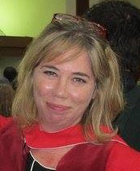 Stephanie Rutherford posing for the camera in academic regalia.