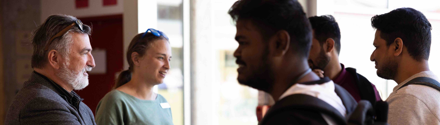 students speaking with faculty at orientation