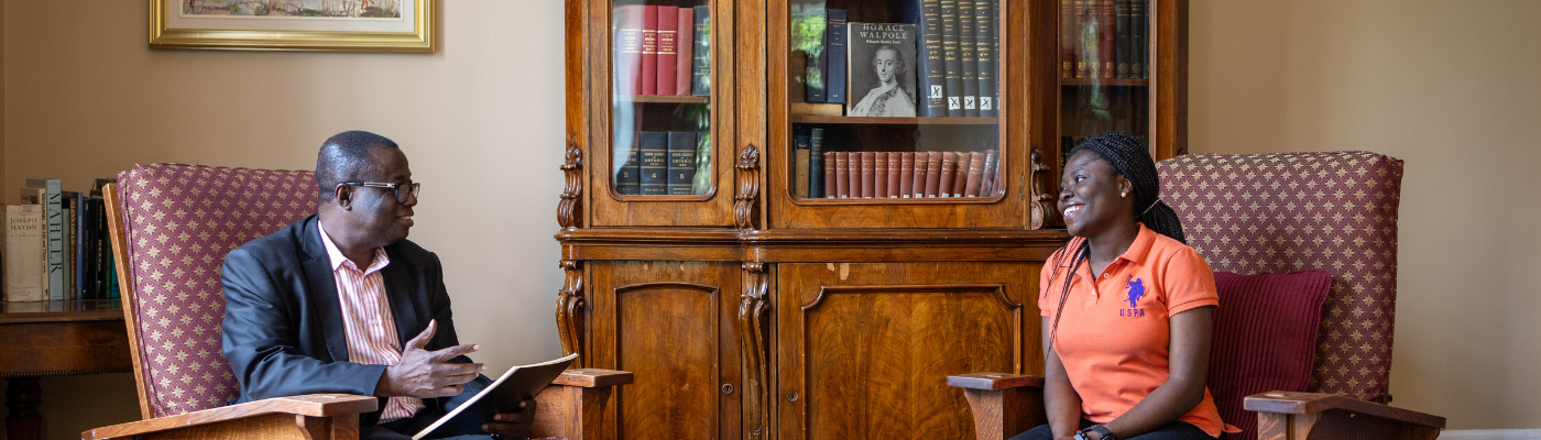 student speaking with faculty for support