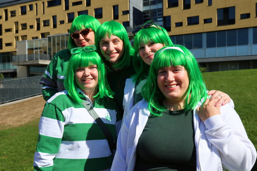 5 students in green wigs on Gzowski College lawn