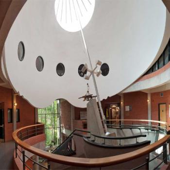 Interior shot of the main entrance of the Environmental Science Building with telescope shaped sculture in the middle of a circular raised portion of the ceiling 