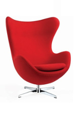 Red high backed chair with curved shape in one piece, with metal feet