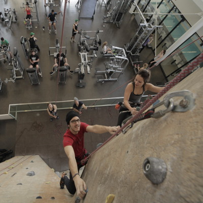 Inside view of the Athletic Centre's workout room with students using the various machines