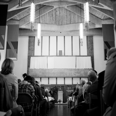 Black and White photo of the interior of Champlain College with a lecture being underway and students sitting in rows
