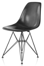 Black fiberglass chair with a very high base holding a one piece seat with no arm rests
