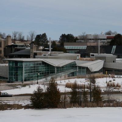 An exterior view of the Chemical Building at Trent University showcasing its windowed main front and enterances 