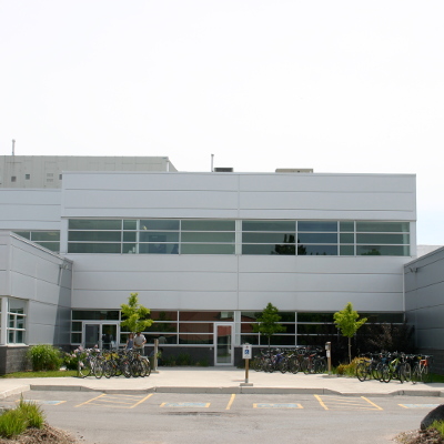 The main entrance of DNA building showcasing its windows and bike racks