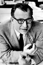 Black and white portrait of Eero Saarinen wearing a suit and gesturing with his hands