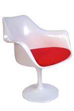 All white chair with a wide base leading into a wider seat with arm rests and a higher back. Red pillow as a seat