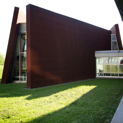 Back exterior of Gzowski College showcasing the brown siding and glass exit