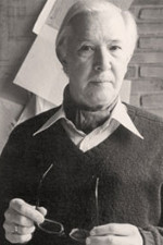 Black and white portrait of Has Wegner holding his glasses and wearing a sweater