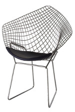 A mesh chair with a cloth seat and metal feet. The backing and sides of the seat are interlocked  shaped metal