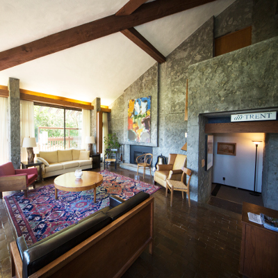 Interior of the Alumni House at Trent with couches  and various chairs designed by Ron Thom