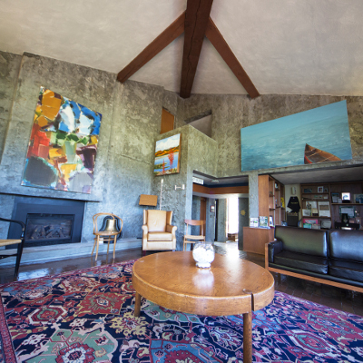 Interior of the Alumni House displaying the re-vitalized Ron Thom furniture including chairs and table
