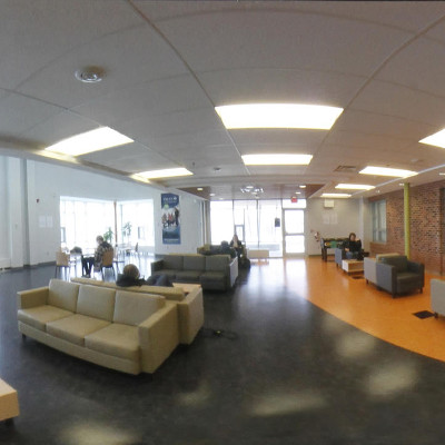 Interior of the Environmental building showcasing the student lounge filled with couches and tables 