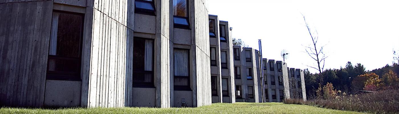 A Lady Eaton College building with lots of windows with a blue sky in the background