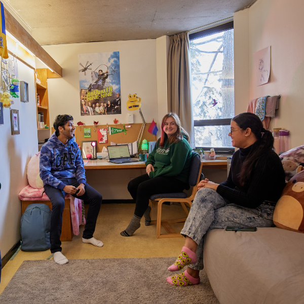 A group of students in their residence room.