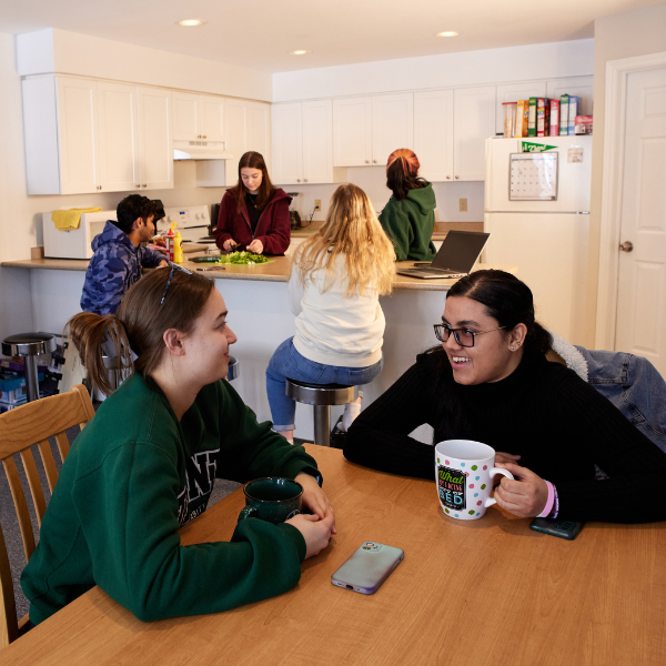 A group of students in their residence room.