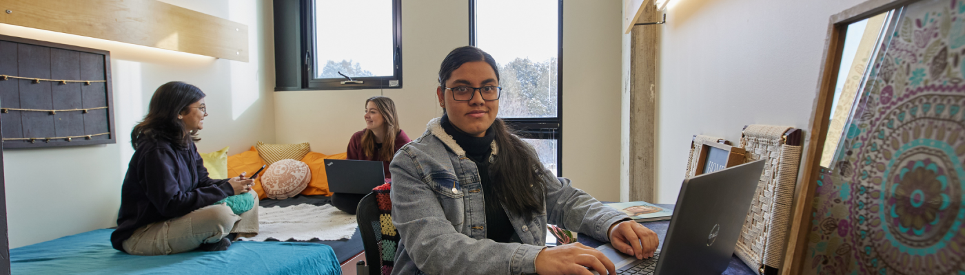 A group of students in their residence room.