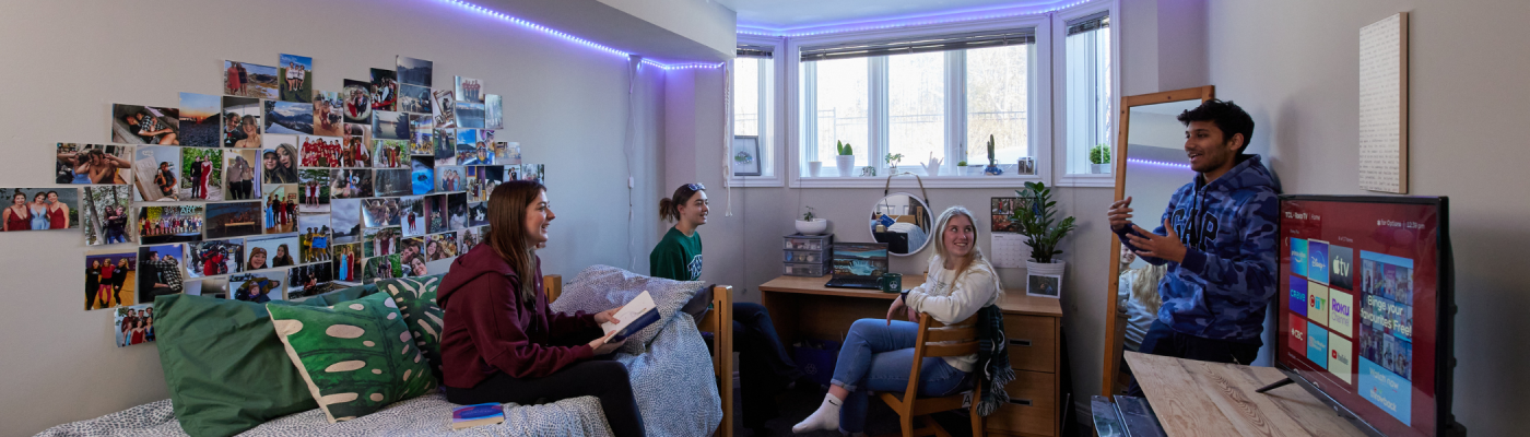 A group of students in their residence room.