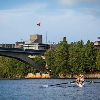 4 athletes rowing on the river 
