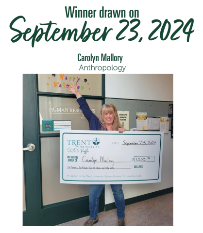 Employee holding large cheque