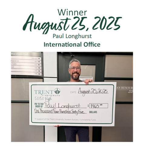 Lottery winner Paul Longhurst holding his cheque